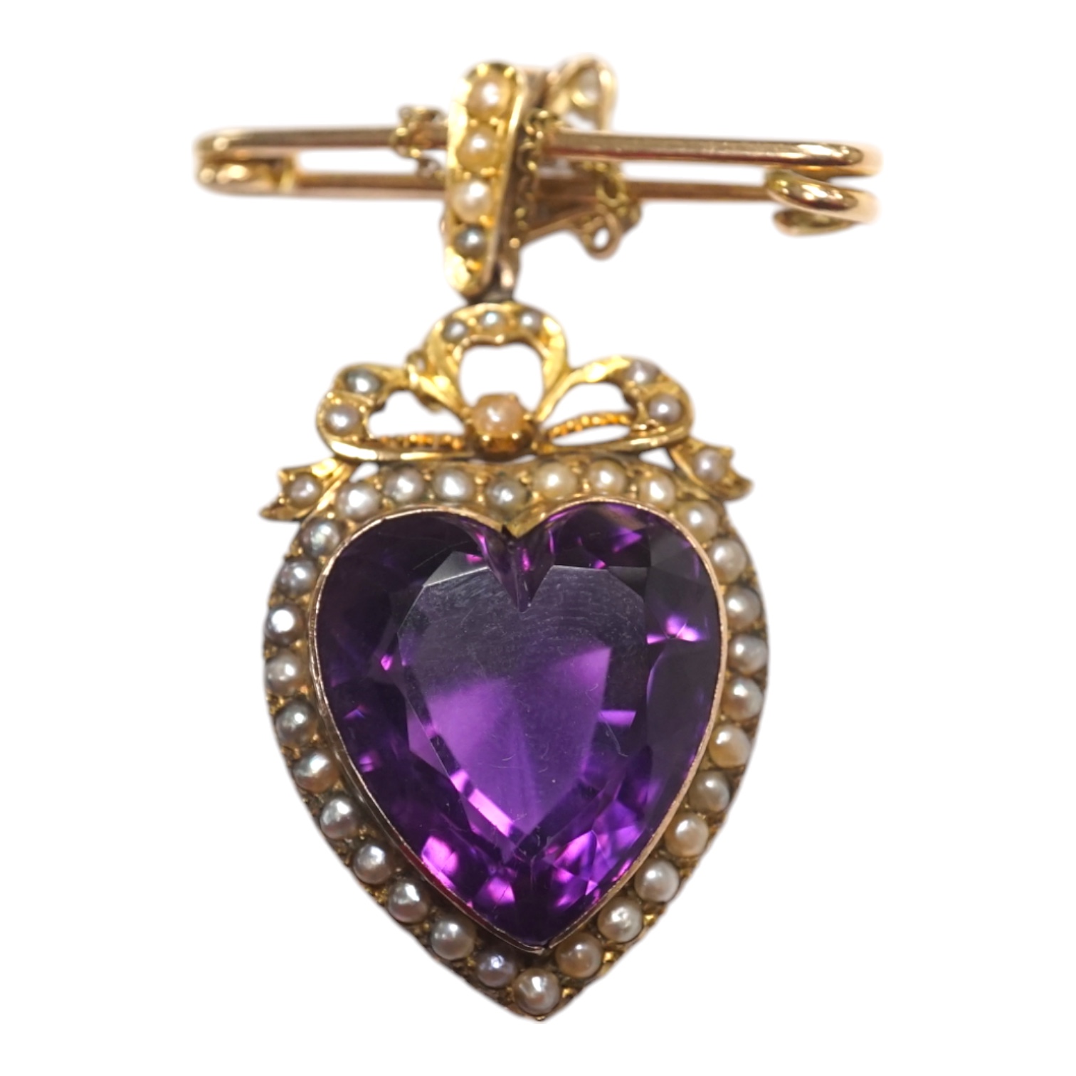 A late Victorian yellow metal amethyst and split pearl cluster set heart shaped pendant, overall 48mm, with later attached 9ct gold brooch attachment, gross weight 14 grams. Condition - fair to good